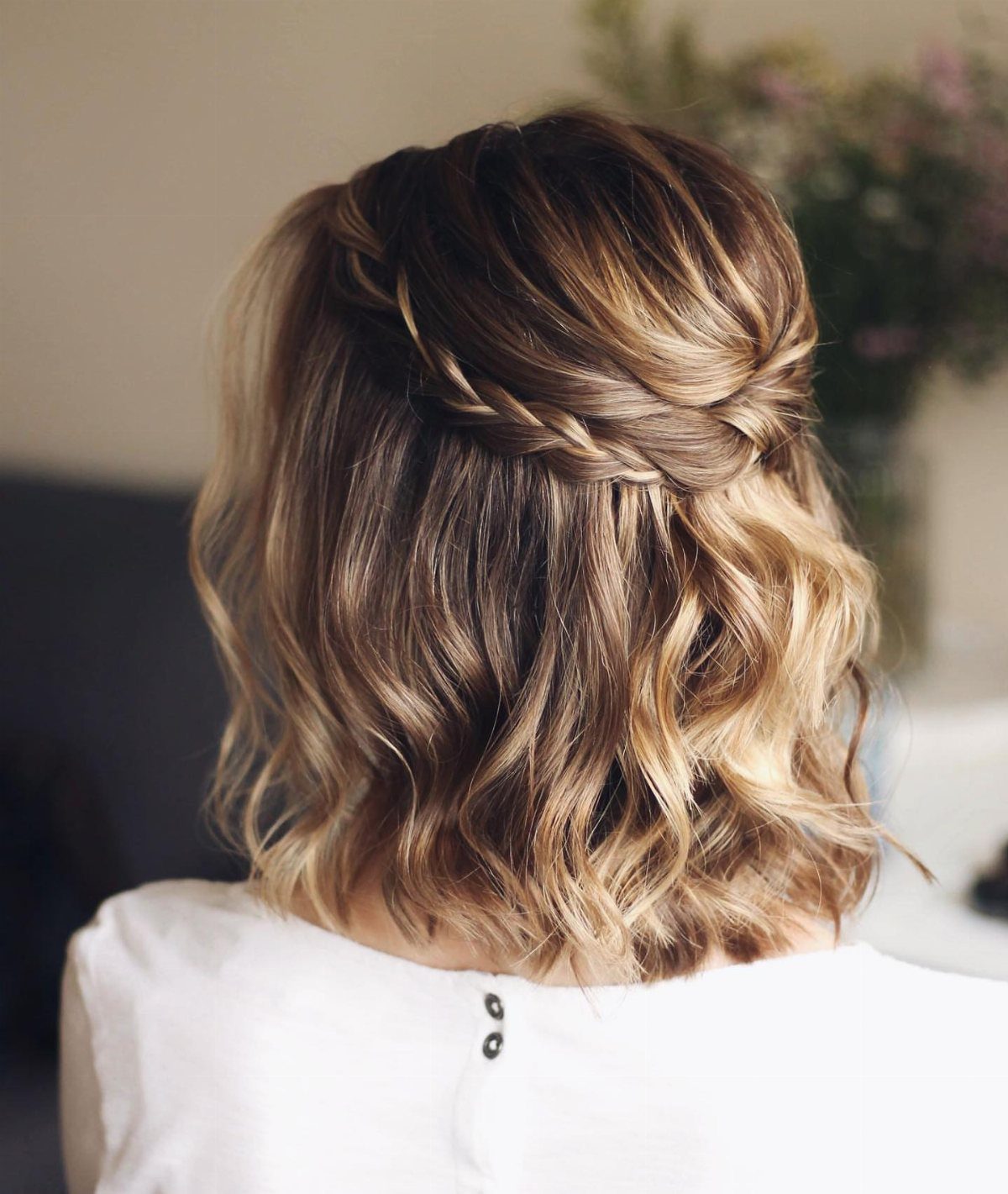 Wavy highlighted bob with a small braid tucked beneath a twist across the back