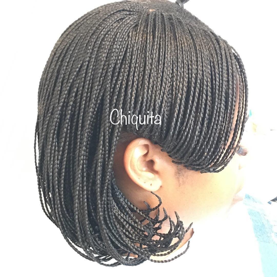 Short braided bob with thin black braids and curled ends near the neck