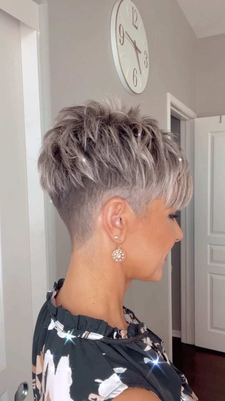 Woman showing a tousled silver-gray pixie cut with textured layers